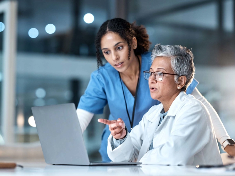 Doctor and nurse looking at a computer.