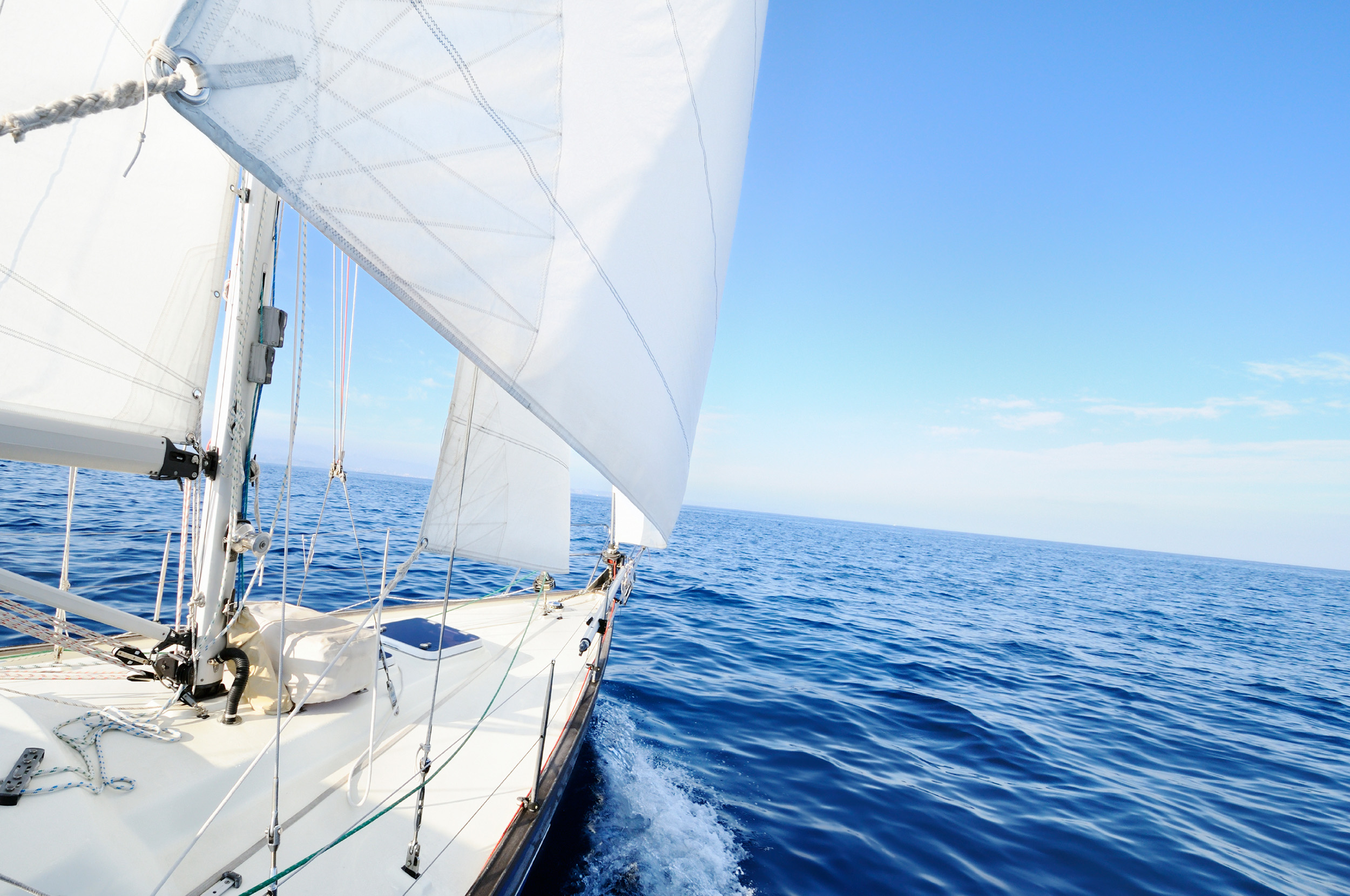 Sailboat in the ocean on a sunny day.