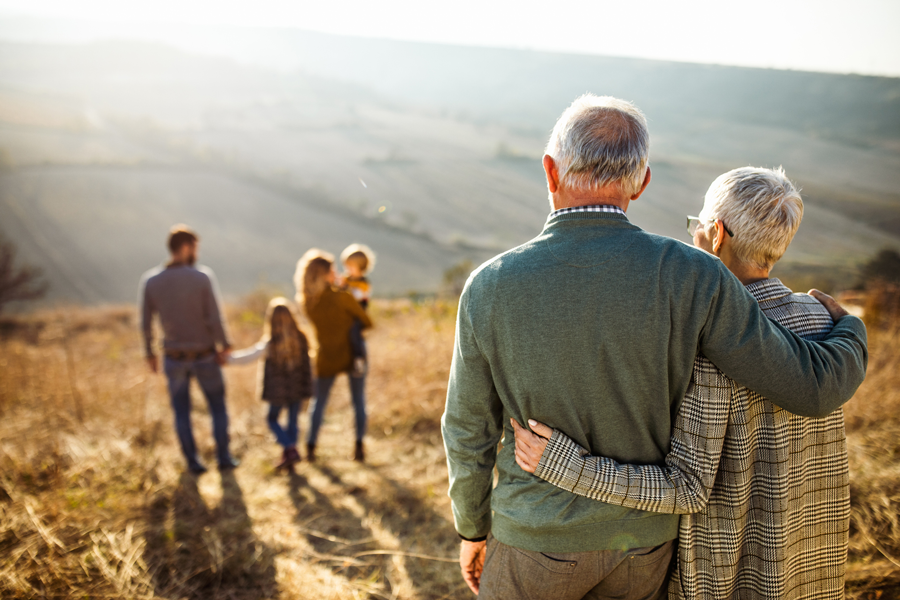Elderly couple watching family.