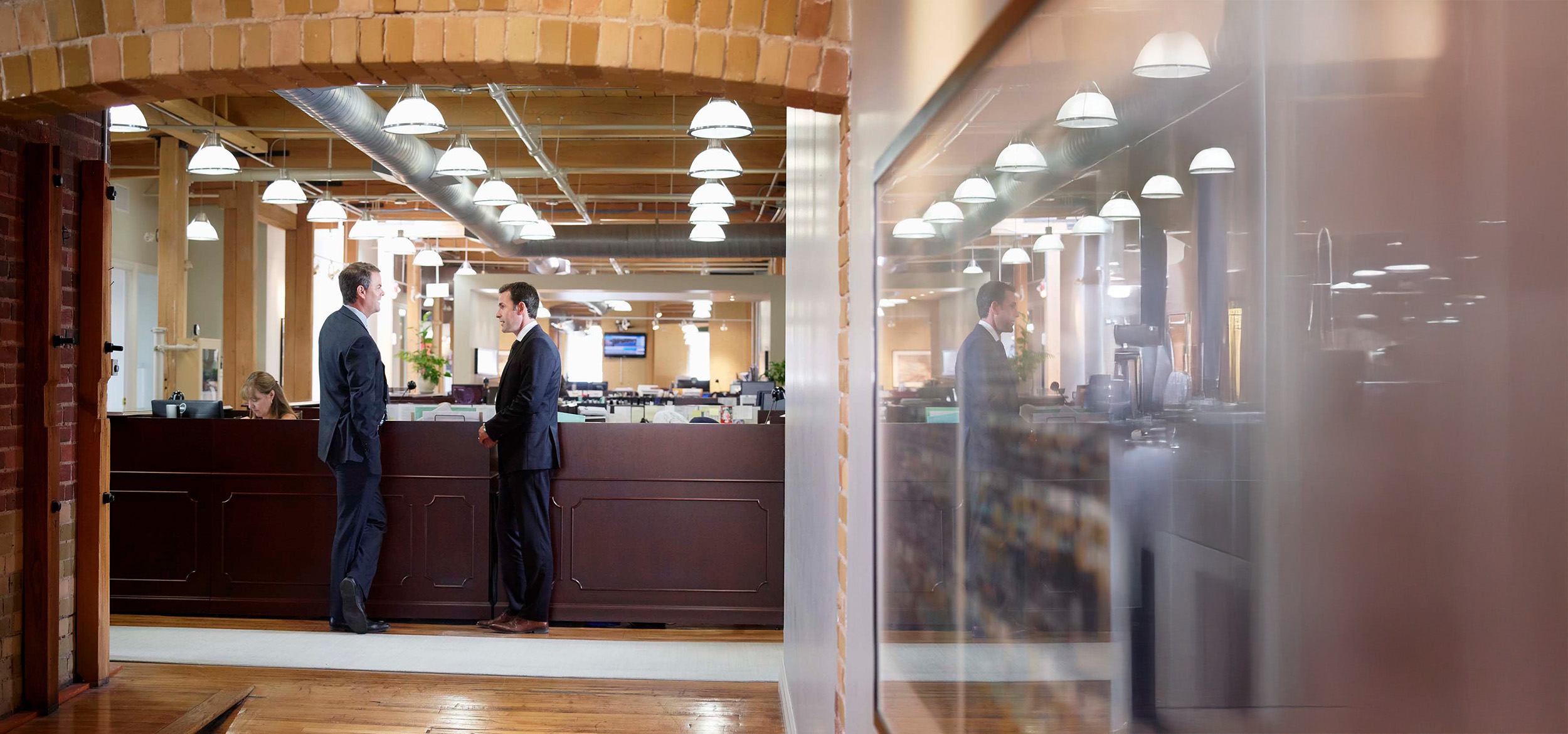 Two men in suits talking.