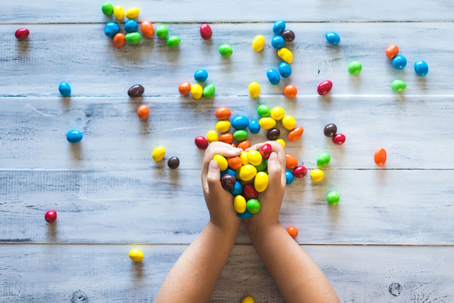 Child's hand holding candies.